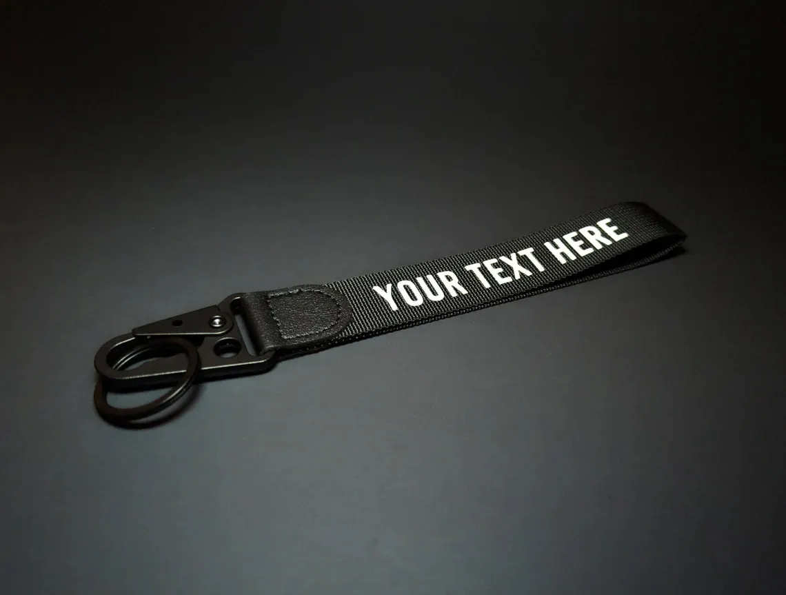 Personalized black wristlet keychain printed with custom white text